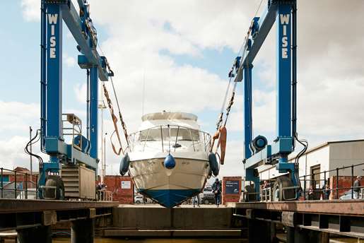 Hull hoisting a boat out of the water.