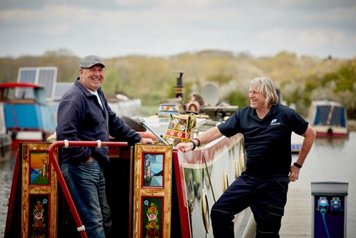 Two men on a narrowboat.
