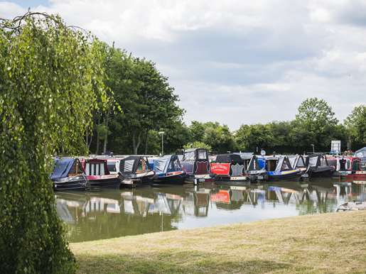 A row of narrowboats at the marina.