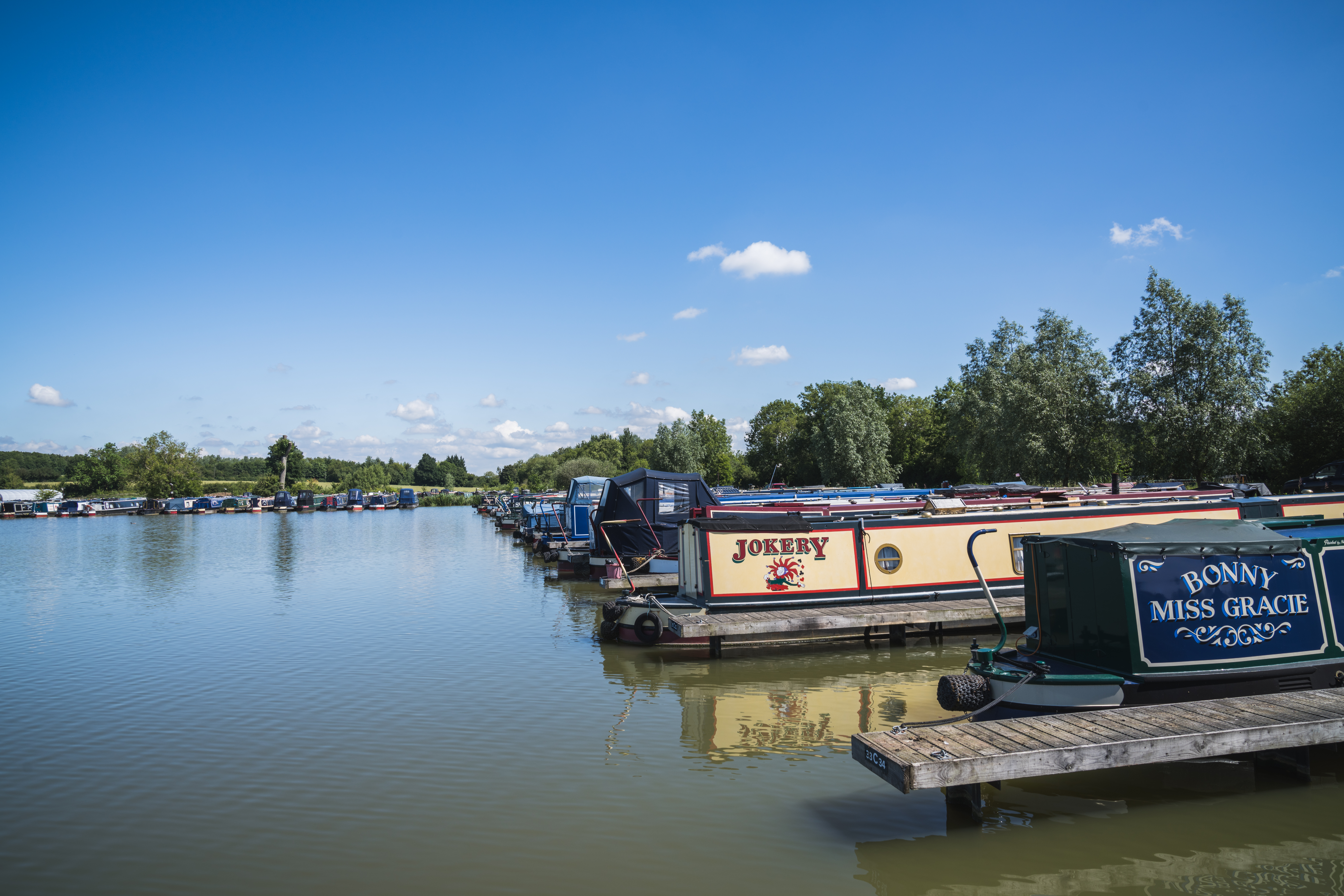 Two boats sit on the water called 'Jokery' and 'Bonny Miss Gracie'.